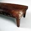Extra large cowhide footstool brown and white with modern tapered leg