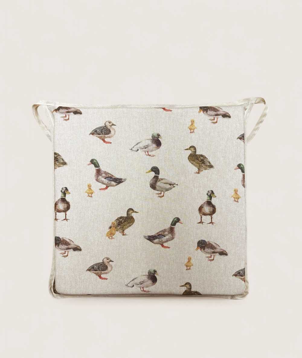 Square shaped non-slip seat pads in beige with a modern duck design