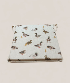 Square shaped non-slip chair pads in beige with a modern duck design