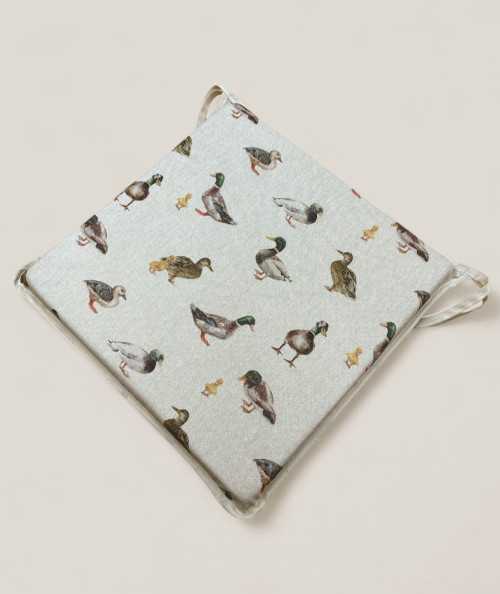 Square shaped non-slip chair cushions in beige with a modern duck design