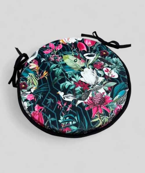 Luxury circular black coloured velvet bistro seat pads with a multicoloured tropical print