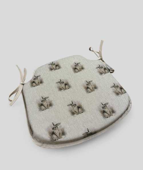 Beige spindle shaped non-slip chair pads with a small rabbit design