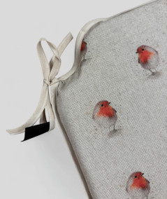 Beige spindle shaped non-slip chair pads with a red robin print