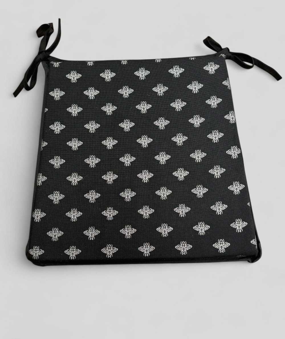 Black tapered seat pads with a silver foil small bee design