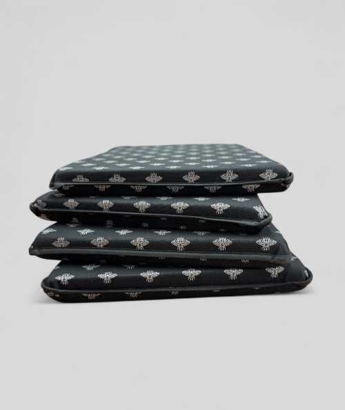 Black tapered chair pads with a silver foil small bee design