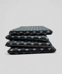 Black tapered chair pads with a silver foil small bee design