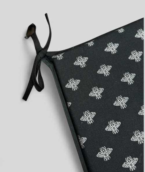Black tapered seat cushions with a silver foil small bee design