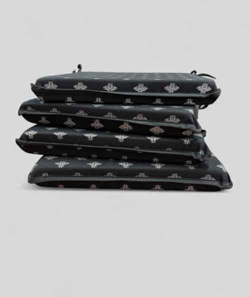 Square shaped black chair pads with a small bee metallic print