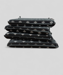 Square shaped black chair pads with a small bee metallic print