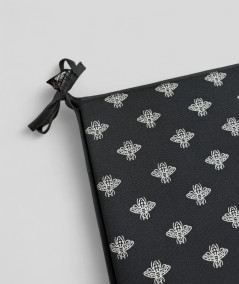 Square shaped black seat cushions with a small bee metallic print