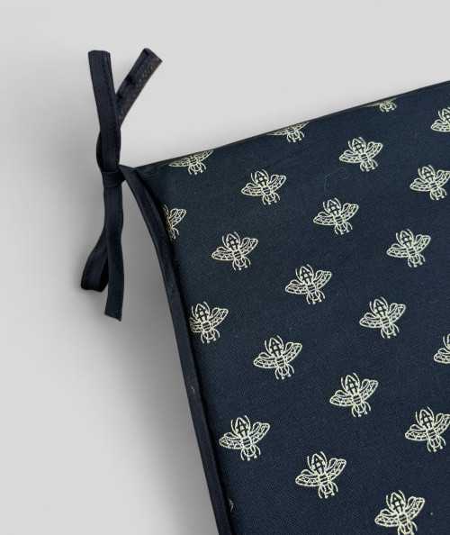 Black tapered chair pads with an all over small gold bee print