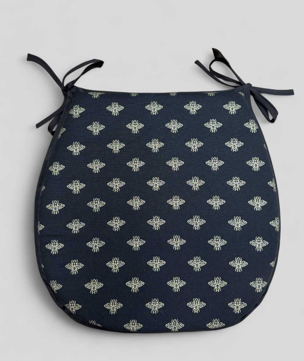 Black classic D shaped seat pads with an all over small gold bee print