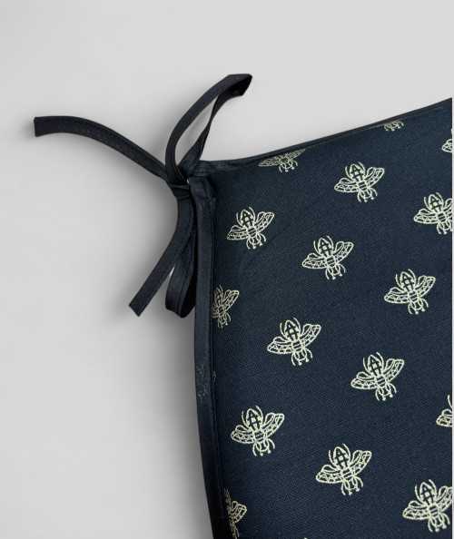 Black classic D shaped chair pads with an all over small gold bee print