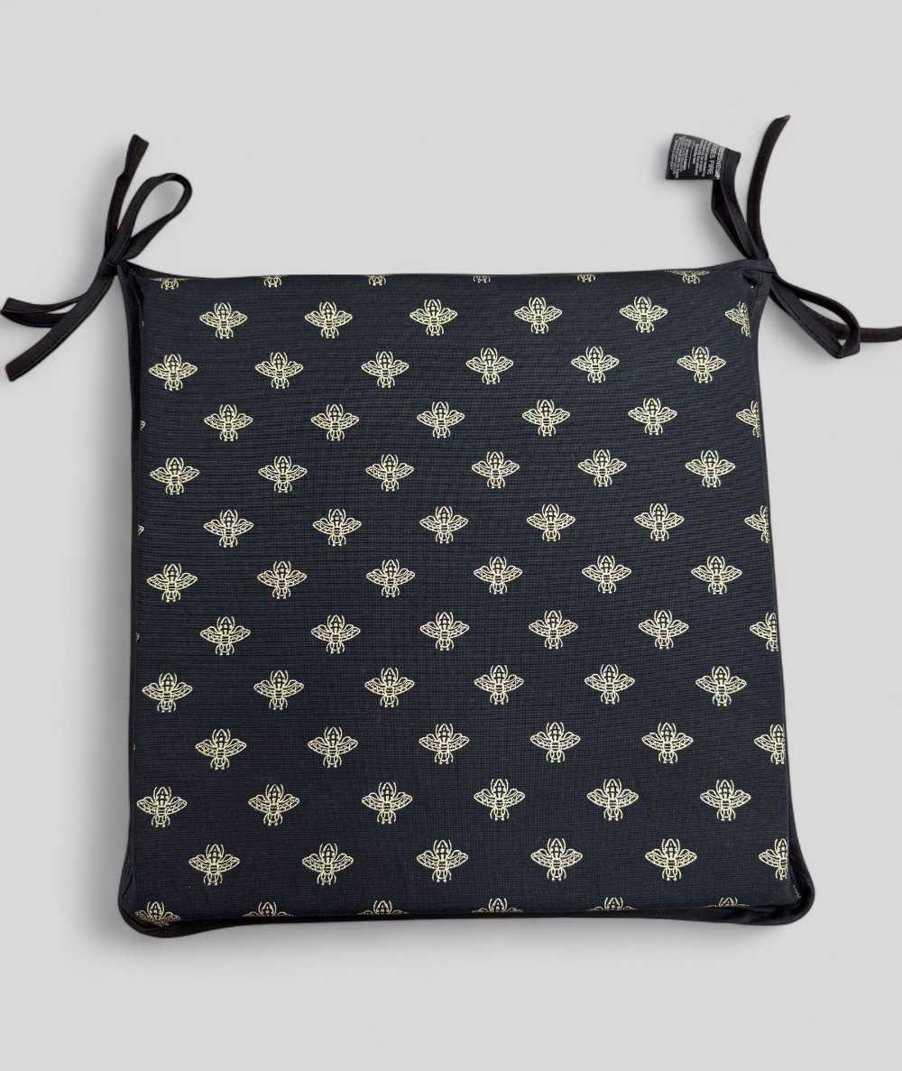 Black square shaped seat pads with an all over small gold bee print