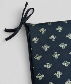 Black square shaped chair pads with an all over small gold bee print
