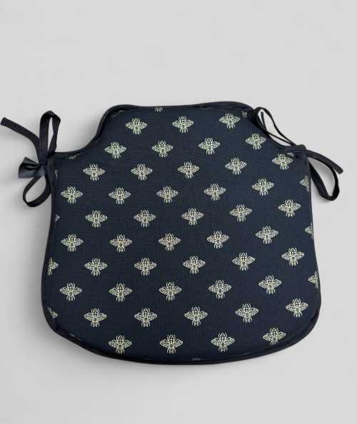 Black spindle shaped seat pads with an all over small gold bee print