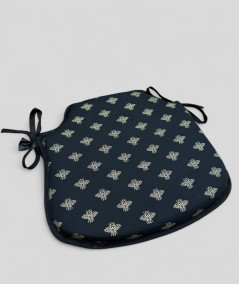 Black spindle shaped chair cushion with an all over small gold bee print