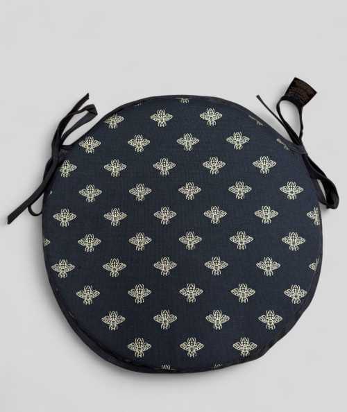 Black circular bistro seat pads with an all over small gold bee print