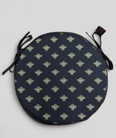 Black circular bistro seat pads with an all over small gold bee print