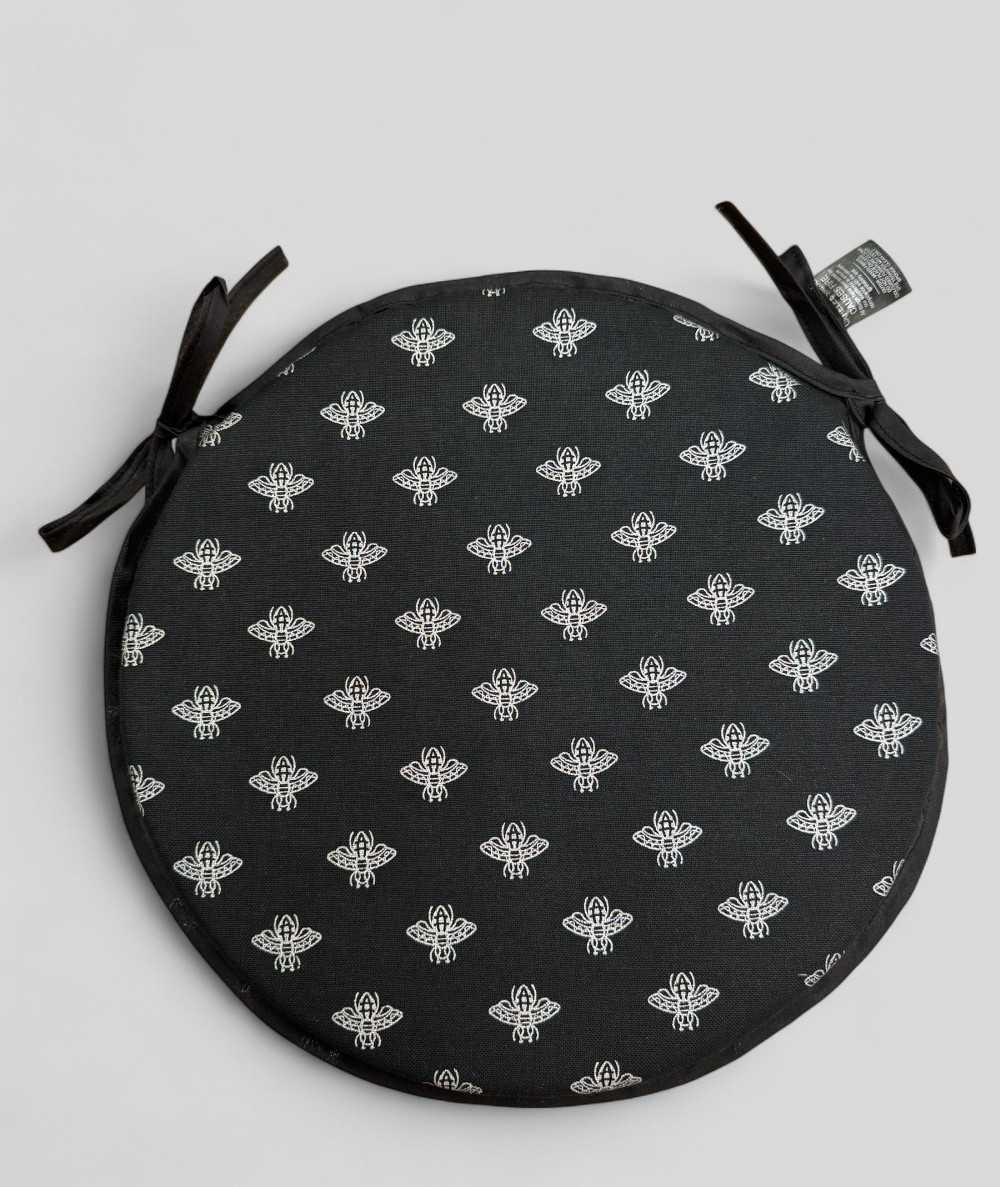 Round black seat pads with an all over small silver bee design