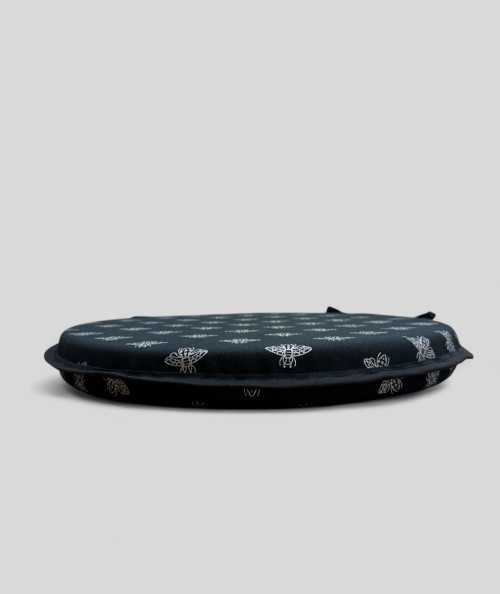 Round black seat cushions with an all over small silver bee design