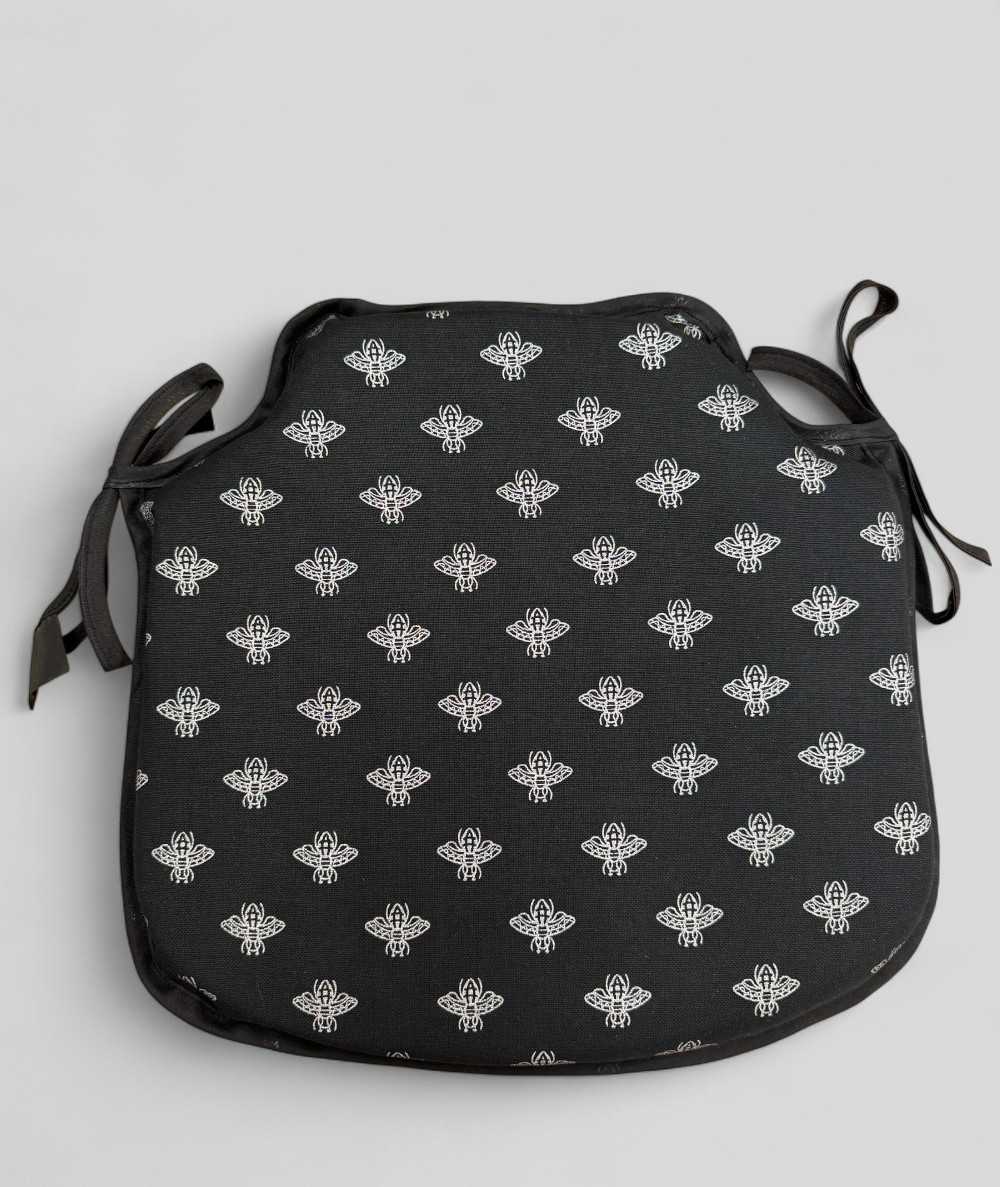 Black spindle shaped seat pads with a small silver bee design